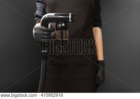 Airbrush For Instant Tanning Tan Spray Body Paint On Black Background In Professional Beauty Salon