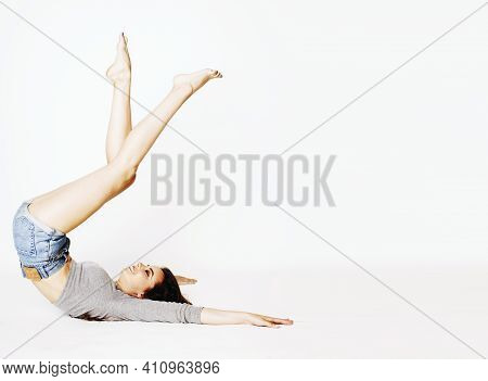 Young Pretty Brunette Woman Head Over Heels On White Isolated