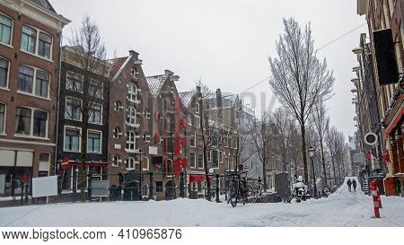Snowy city Amsterdam in the red light disrict in the Netherlands in winter