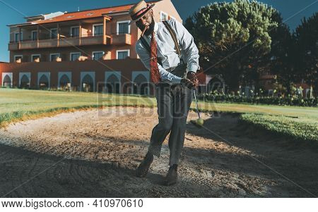 A Fancy Dapper Mature Black Guy In An Elegant Outfit With Trousers With Suspenders, Hat, Tie, With A