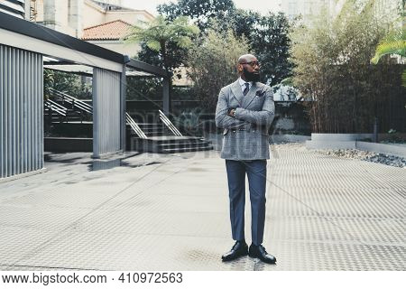 A Handsome Dapper Hairless Adult Black Man Entrepreneur In Elegant Eyeglasses And A Fashionable Cust