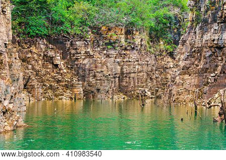 Beautiful Landscape With Sedimentary Rock Walls With Golden Tones And Some Dry Tree Branches Out Of 