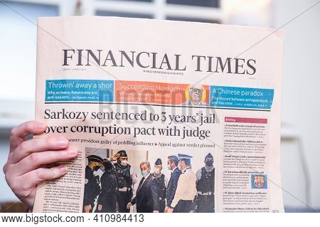 Paris, France - Mar 2, 2021: Close-up Woman Reading Financial Times Newspaper With Headline Former F