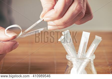 Hand reaching for acupuncture needle