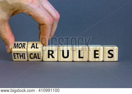 Ethical Or Moral Rules Symbol. Businessman Turns Wooden Cubes And Changes Words 'ethical Rules' To '