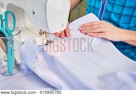 Womans Hands Sew On A Sewing Machine Close Up