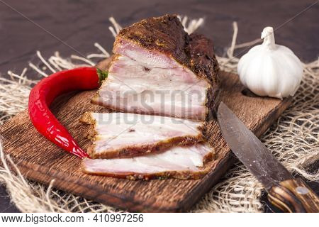 A Piece Of Baked Meat With Layers Of Bacon, Cut From The Bottom Of A Pork Carcass, Along With The Sk
