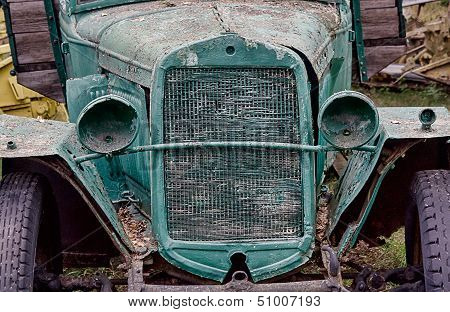 Old Abandoned Rusted Truck With Empty Headlamps