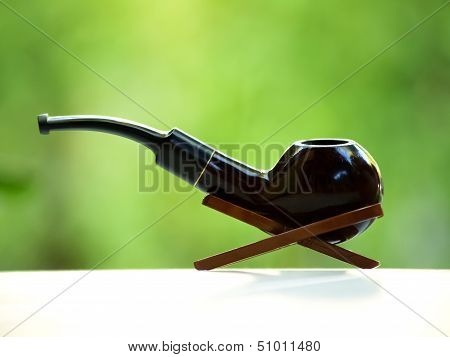 Smoking pipe in its stand