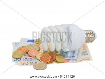 energy saving lamp bulb on euro money