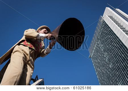 Performer Calls People Using A Vintage Loudhailer At Milan Clown Festival 2014