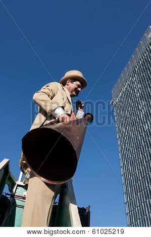 Performer Calls People Using A Vintage Loudhailer At Milan Clown Festival 2014