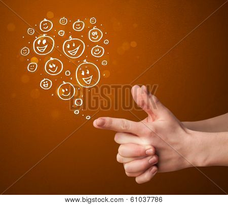 Group of happy hand drawed smiley faces coming out of gun shaped hands