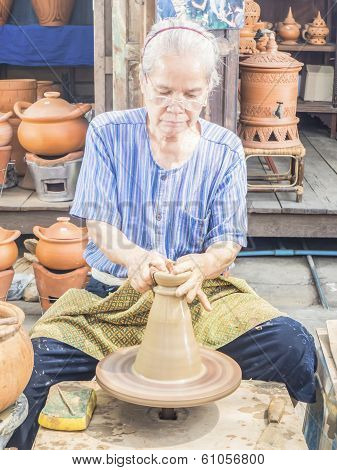 Senior Potter Shaping Up The Clay Pot On Wheal