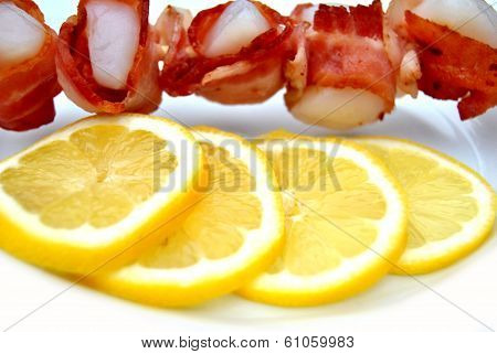 Lemon Slices With Scallops Wrapped In Bacon