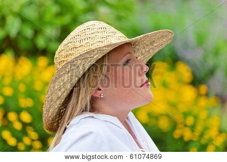 a young woman sits at rest in the meadow. lunch in the park.