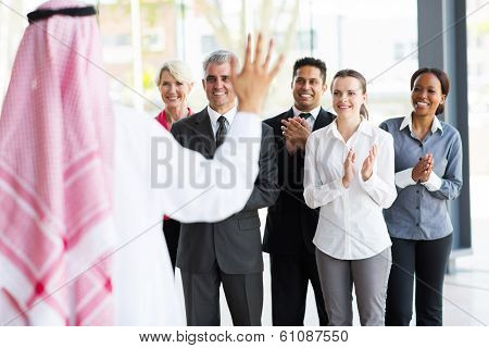 business team applauding to welcome arabian business partner