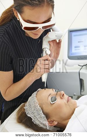 Beautician Carrying Out Q Switch Laser Treatment