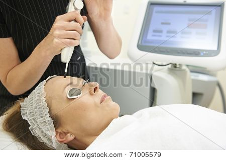 Beautician Carrying Out Q Switch Laser Treatment