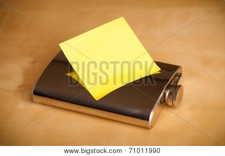 Hip flask with empty sticky note