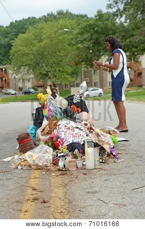 FERGUSON, MO/USA - AUGUST 30, 2014: A woman at makeshift memorial where black teenager Michael Brown was shot to death by police in Ferguson, Missouri.