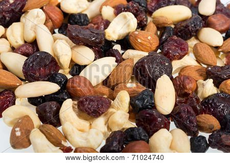 mixed nuts and dried fruits isolated on white background