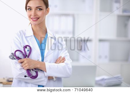 Portrait of happy successful young female doctor holding a stet