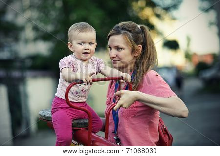 Small girl with her mother playing