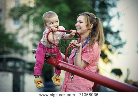 Small girl with her mother playing