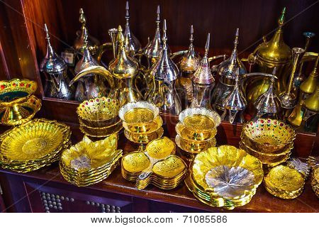 Row Of Shiny Traditional Coffee Pots And Lamp
