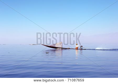 Myanmar, Shan state, Inle lake Intha fisherman on boat at early sunrise 