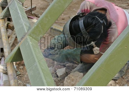 Welder with protective mask welding metal