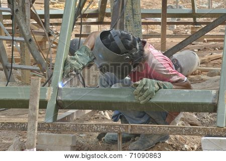 Welder with protective mask welding metal