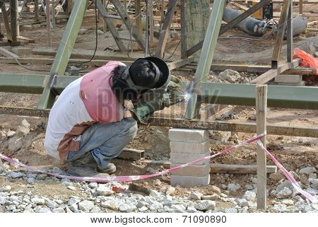 Welder with protective mask welding metal