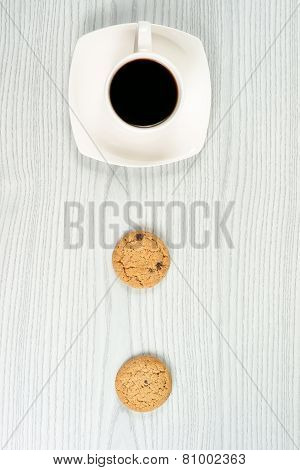 Coffee cup with two oatmeal cookies