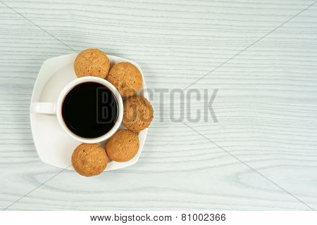 Coffee cup with homemade oatmeal cookies