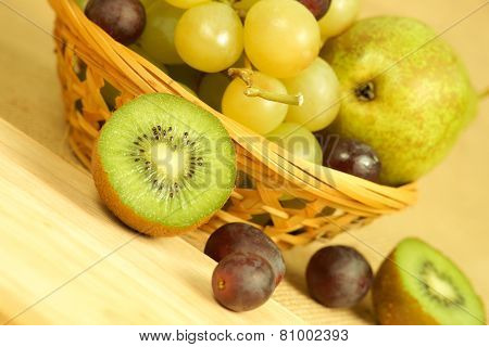 Cutted kiwi and fruits basket