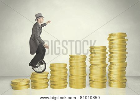 Business man riding monocycle up on coin graph concept on background