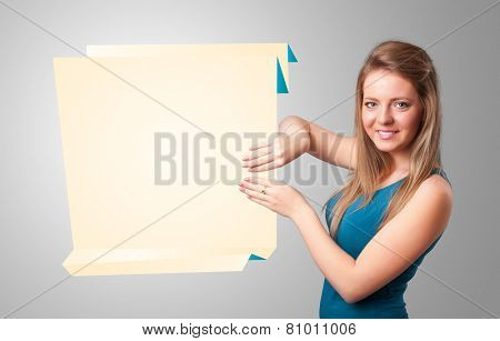 Baeutiful young woman holding white origami paper copy space