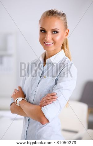 Attractive businesswoman with her arms crossed stnding