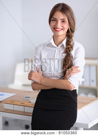 Attractive businesswoman with her arms crossed stnding