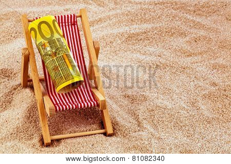 a deck chair with a euro banknote. photo icon for save on holiday and when traveling