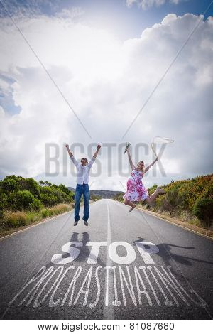 Excited couple jumping on the road against stop procastinating