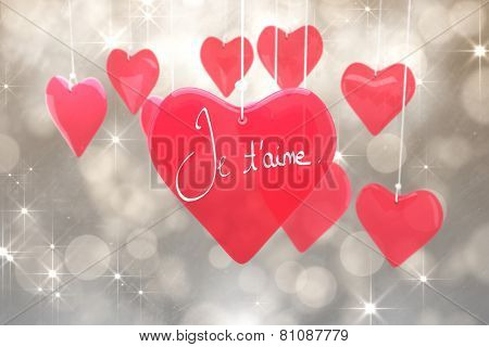Valentines love hearts against shimmering light design on grey