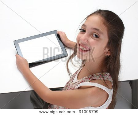Beaitiful pre-teen girl using a tablet computer.