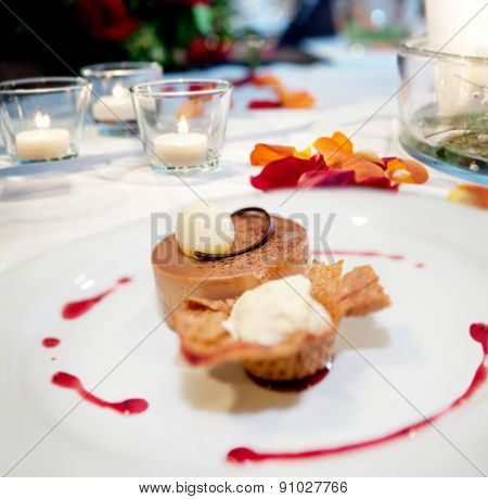 Dessert plate in restaurant. Cookie, ice cream and cake. Table background romantic restaurant.