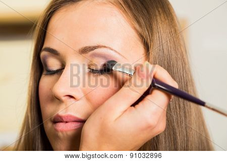 Makeup artist paints the eyebrows model. painting of eyebrows.