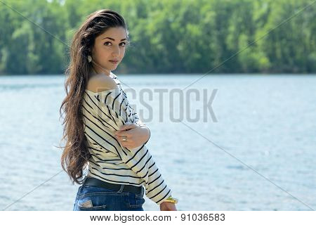 pretty girl on the beach look at water