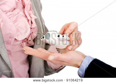 Caucasian businesswoman giving a plane to her partner.