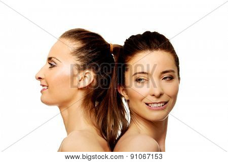 Two attractive topless sisters with make up.